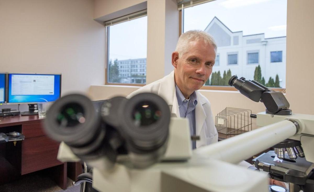 Dr. Thomas Clark, Pierce County chief medical examiner, is shown March 4, 2016 in his office with a teaching microscope.
