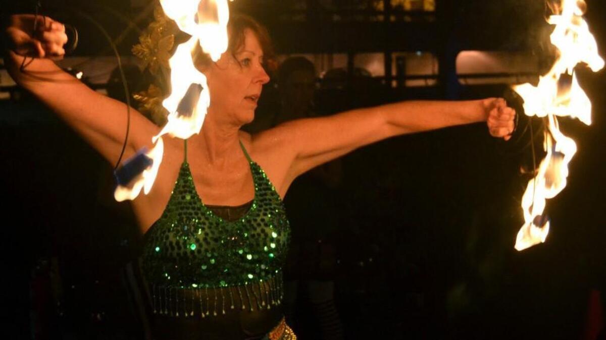L. Lisa Lawrence dances with fiery fans at last year’s First Night celebrations in downtown Tacoma.