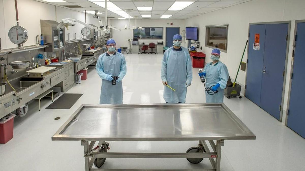 Staff members are shown Friday in the autopsy room inside the Pierce County Medical Examiner’s offices. From left: Jacob Atzet, death investigator, Chris Kelley, forensic autopsy technician, and Terry Jaeger, forensic autopsy technician.