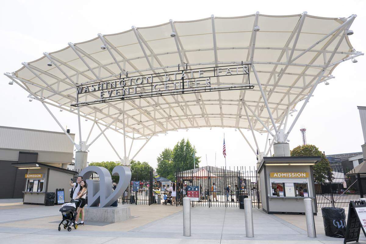 People enter the Washington State Fair Event Center from the Golden Gate on Thursday, Sept. 4, 2025, in Puyallup, Wash.
