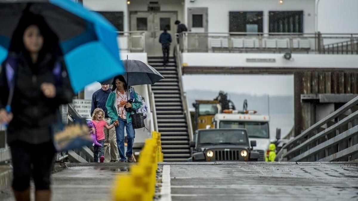 Commuters disembark from the Steilacoom II ferry in Steilacoom. Pierce County is considering a plan to add an early morning run to the ferry system for Anderson Island commuters.