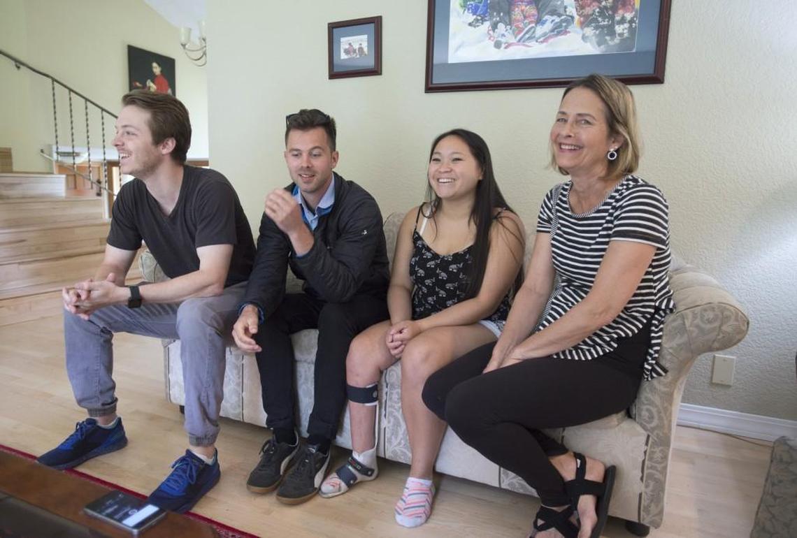 Joeli Reim with two of her three brothers, Gavin Reim (far left) and Grayson Reim, and her mom, JoAnn Knecht, at the family's home in Fircrest on June 27.