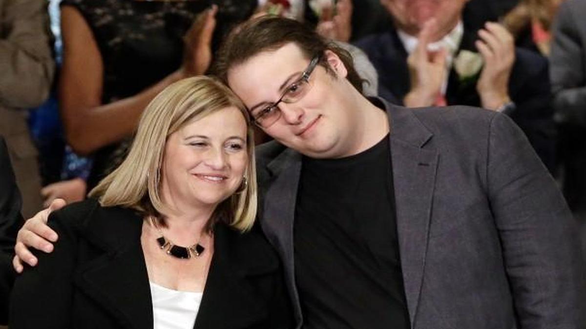 Nashville Mayor Megan Barry, center, is hugged by her son, Max, as her husband, Bruce, left, applauds after she was sworn into office in Nashville, Tenn. A statement released Sunday, July 30, 2017, from Megan and Bruce Barry, said their only child, Max Barry, died Saturday night in Denver from an apparent drug overdose.