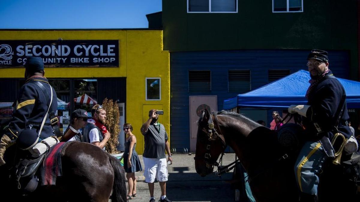 Riders with the Ninth and Tenth Horse Cavalry Buffalo Soldiers Museum ride through the Hilltop Street Fair on Saturday. The riders were popular with festival goers. Many stopped to take pictures. Others wanted to pet the horses.