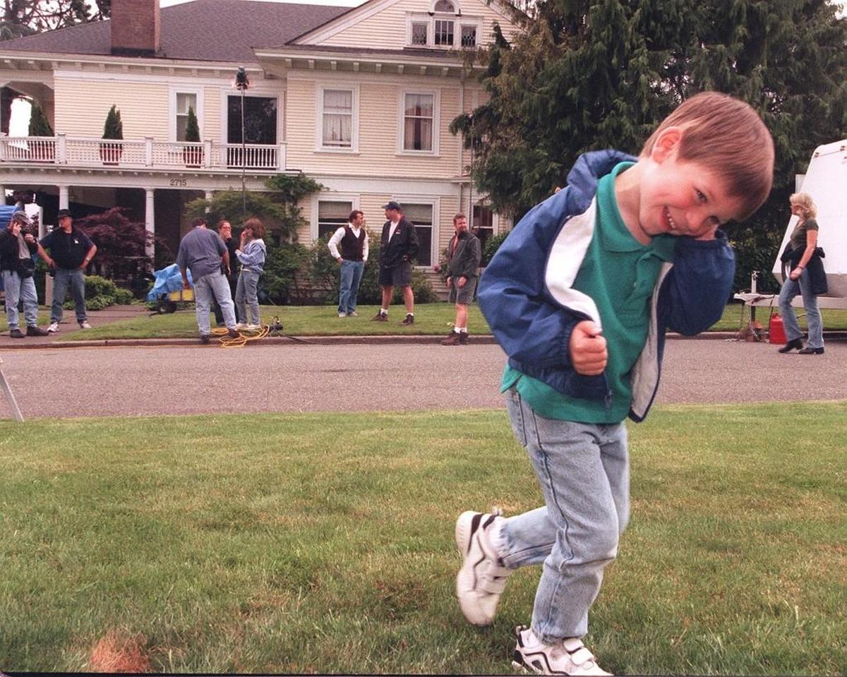 Four year-old Adam Estenson gets a kick out of the moviemaking activity in his North End neighborhood. Adam and his mother stopped by to watch the first day of filming for the Touchstone Pictures movie, “10 Things I Hate About You.”