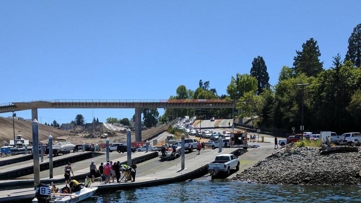 Emergency medical service personnel transport an injured Australian skier to an ambulance from the Point Defiance Park boat ramp in Tacoma on Saturday.
