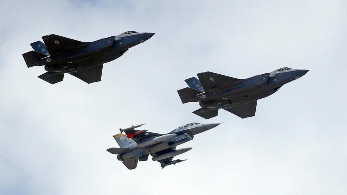 An F-16, below, escorts two F-35 jets, above, at Hill Air Force Base, in northern Utah. Air Force officials face a pilot shortage as airlines ramp up hiring and some potential pilots balk at the military’s lifestyle demands.