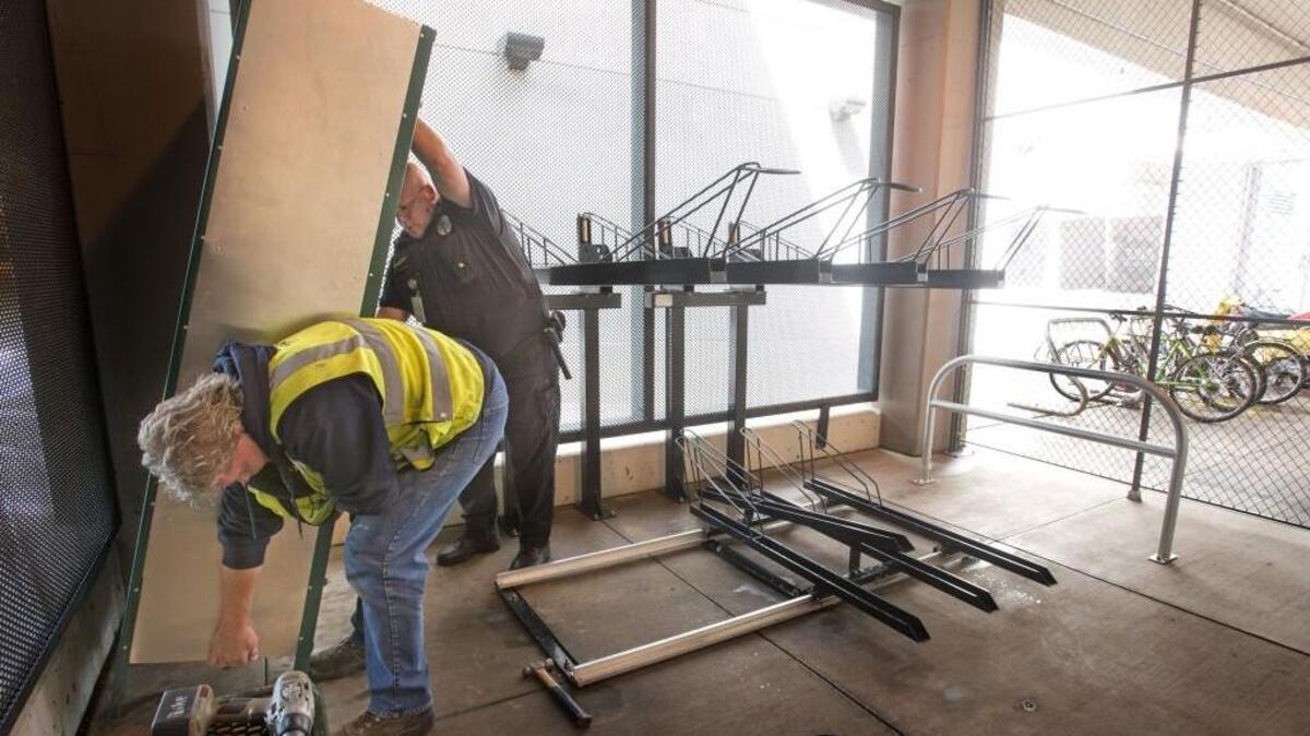 Pierce Transit facilities maintenance mechanic Michael Mitsules gets help from Pierce Transit Public Safety Sgt. Paul Strozewski finishing the bicycle-storage area at the Tacoma Dome Station on Monday. The storage area is designed to hold up to 17 standard-size bikes and two oversize or tandem bikes.