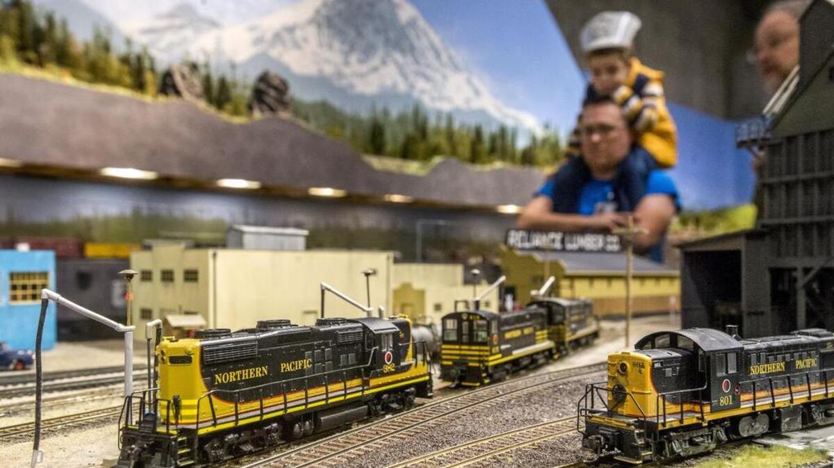 Nathan and Jordan Richardson of Auburn get a behind-the-scenes view of the Puget Sound Model Railroad Engineers exhibit at the 20th annual Model Train Festival at the Washington State History Museum in Tacoma on Saturday.