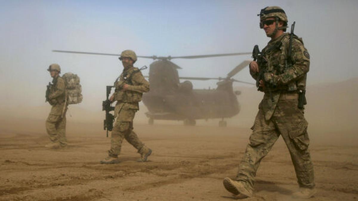 FILE - In this Saturday, Jan. 28, 2012 file photo, U.S. soldiers, part of the NATO- led International Security Assistance Force (ISAF) walk west of Kabul, Afghanistan. NATO Secretary-General Jens Stoltenberg is playing down differences among member countries as the military alliance marks its 70th anniversary in Washington on April 4, 2019.