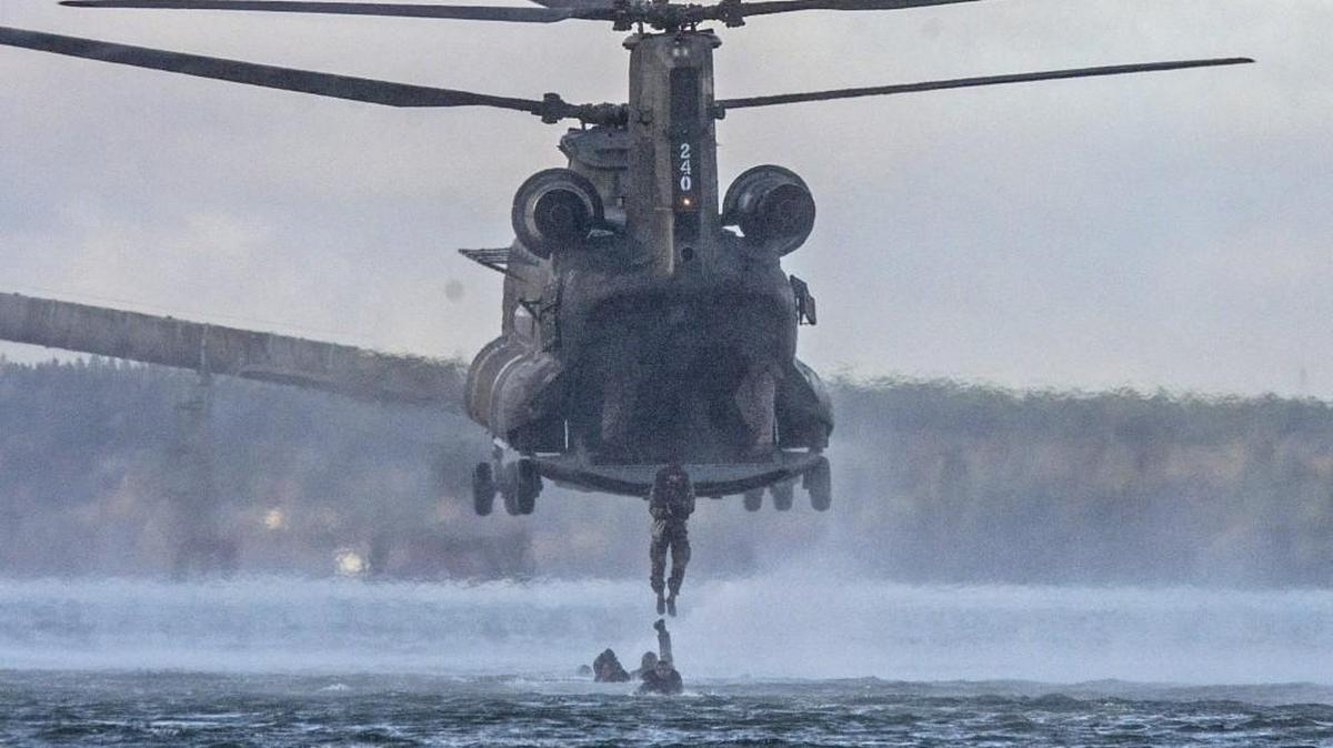 Soldiers from the 1st Special Forces Group and Indian Army Special Forces drop from a helicopter into Puget Sound on Friday as part of “Vajra Prahar,” a joint training exercise at Joint Base Lewis McChord.