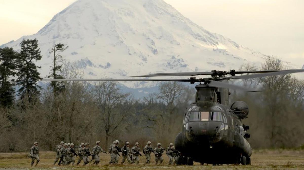 Soldiers rush to mount a CH-47 Chinook helicopter after completing an air assault mission in 2013.