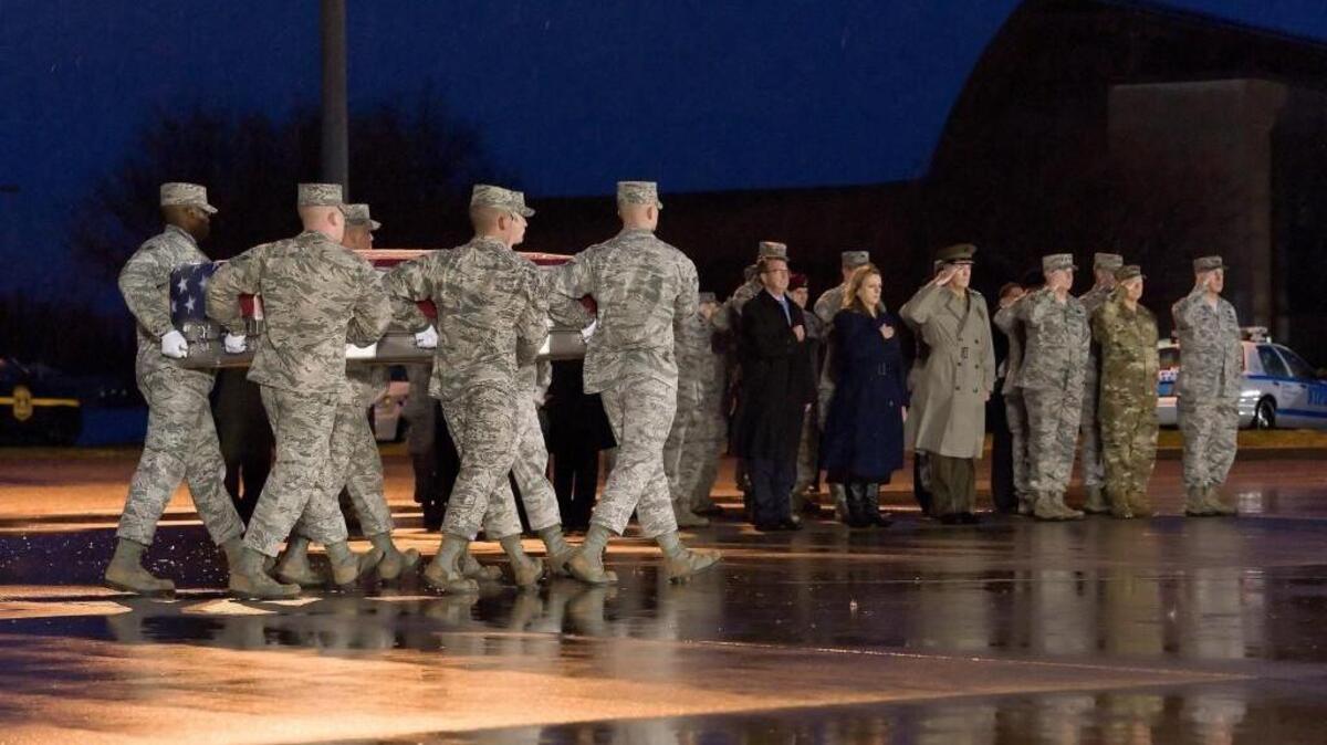 A U.S. Air Force carry team transfers the remains of Staff Sgt. Chester J. McBride, of Statesboro, Georgia, during a ceremony Dec. 23 at New Castle Air National Guard Base, New Castle, Delaware. He was one of six airmen killed in a suicide attack on Dec. 21 at Bagram Airfield.