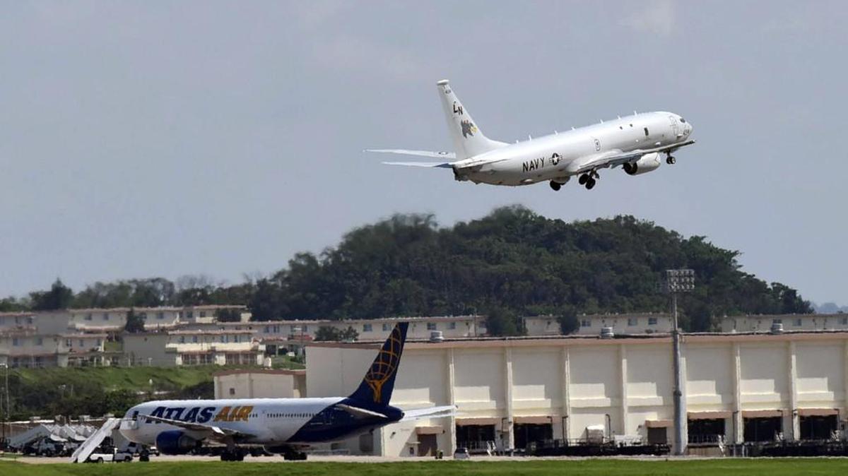 A P-8 practices touch-and-go maneuvers at Kadena Air Base in Okinawa where the plane, which specializes in submarine detection, will patrol the Pacific where China has been testing Japan's air space and waters.