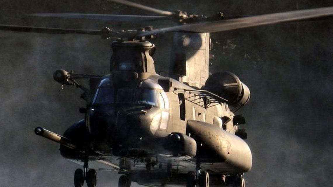 An airman jumps out of an MH-47 Chinook helicopter during an exercise with soldiers from the 160th Special Operations Aviation Regiment at American Lake on JBLM. The military is looking for new places for its helicopter units to train in Washington state.