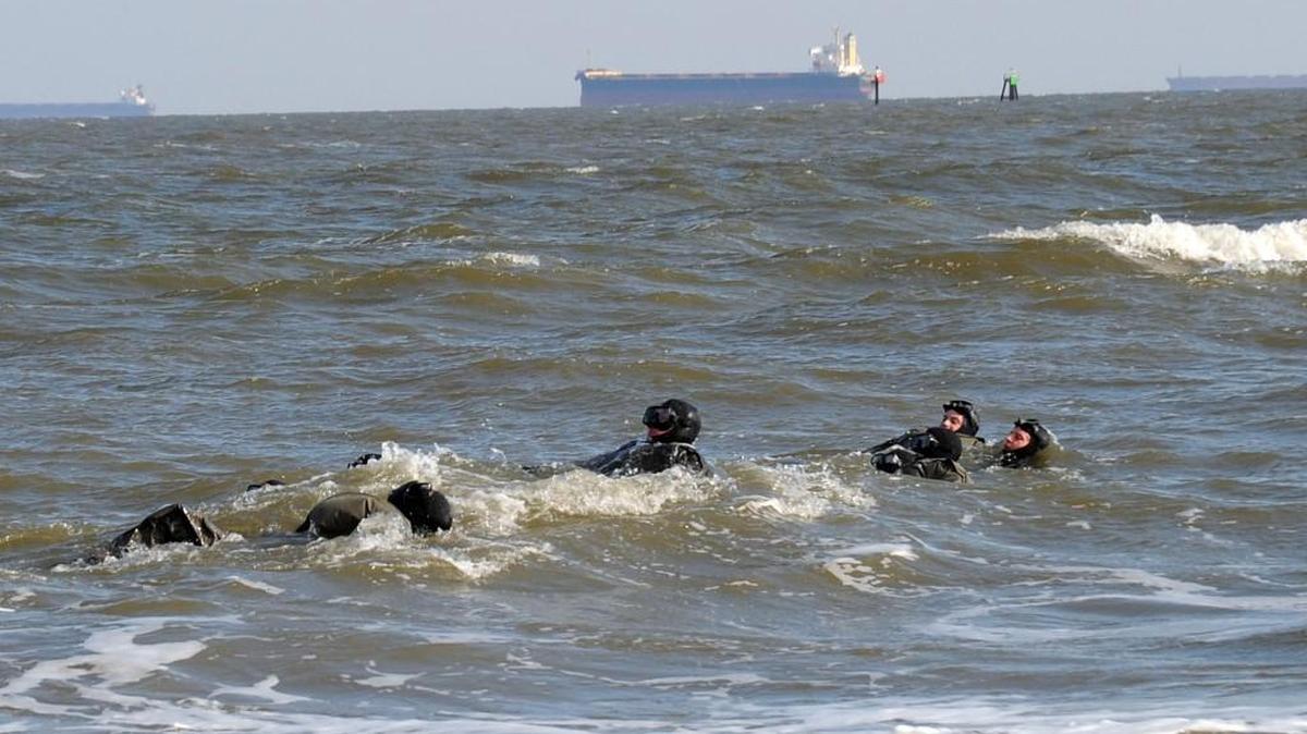 The Navy wants to expand its Special Warfare training in the Puget Sound because of its cold-water challenges and its proximity to large Navy bases. This image shows a cold-water swim off Virginia Beach in February 2010.