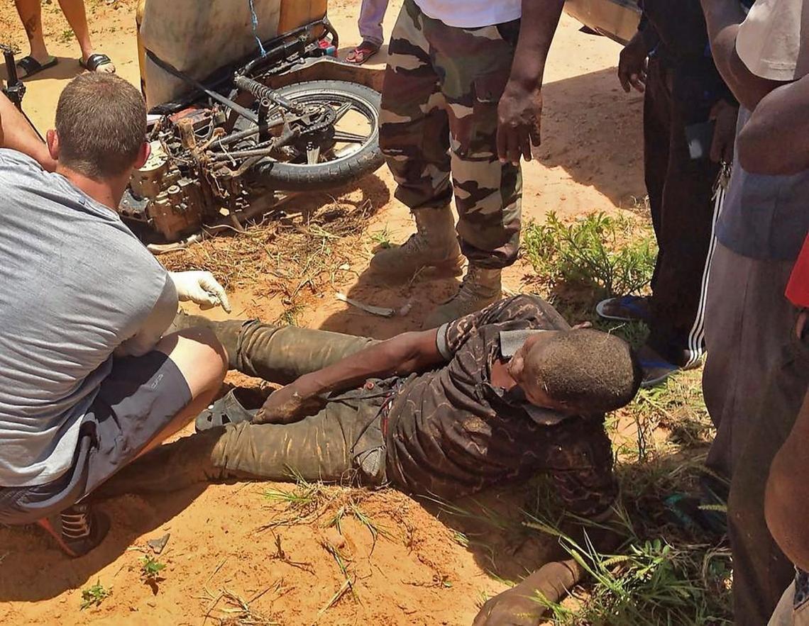 Staff St. Bryan Black (back to camera) treats an unidentified man in Niger who sought medical aid. Black, trained as a medic, set up a surgical tent and performed surgery on the man’s injured leg.