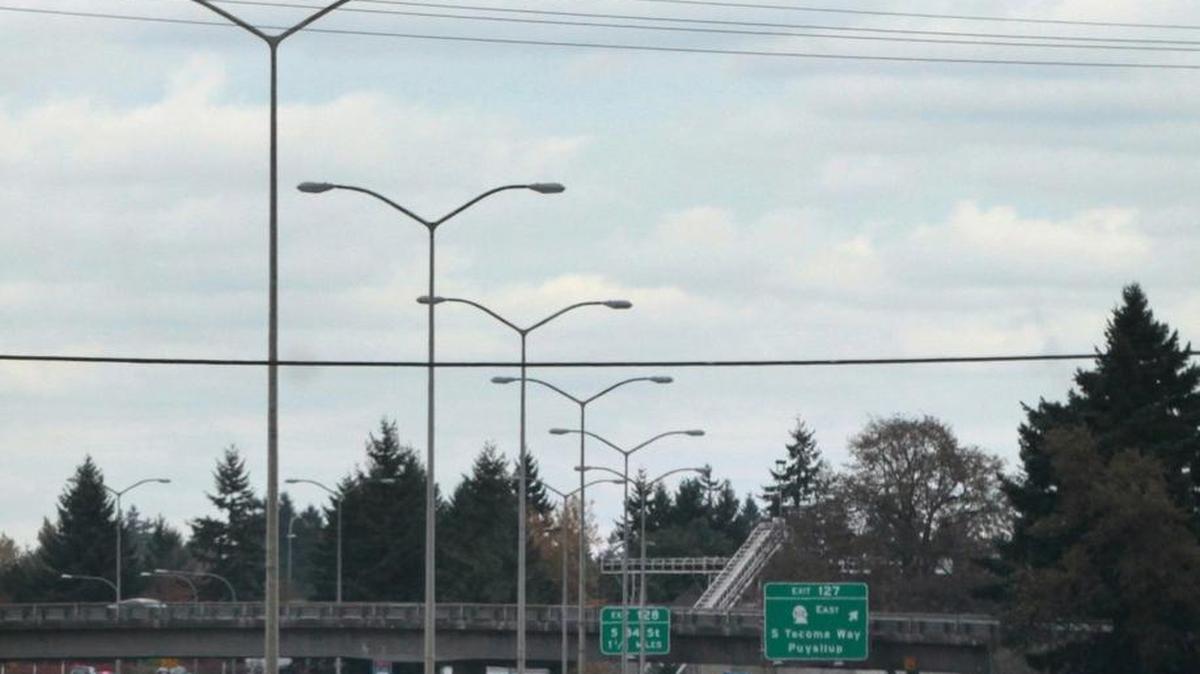 FILE PHOTO: An Air Force C-17 Globemaster flies over Interstate 5 in Lakewood on approach to McChord Airfield on Oct. 30, 2013. A new survey shows that Pierce and Thurston County residents believe Joint Base Lewis-McChord has an overall positive impact on their communities, but they want to see more efforts that would ease traffic and limit noise from military training.