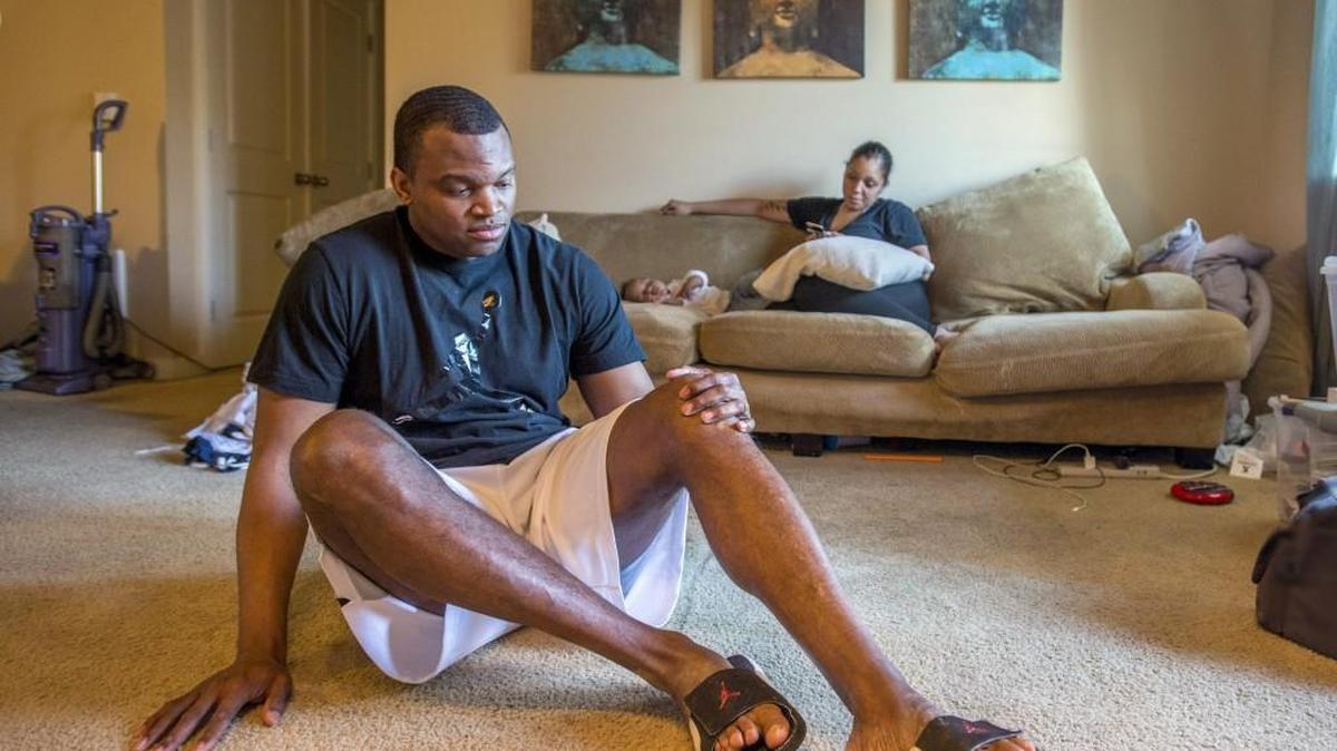 Spc. Charles Wylie at home. He is to receive a medical retirement from the army due to knee and shoulder injuries. His wife Lauren Wylie and son Chayton are in background.