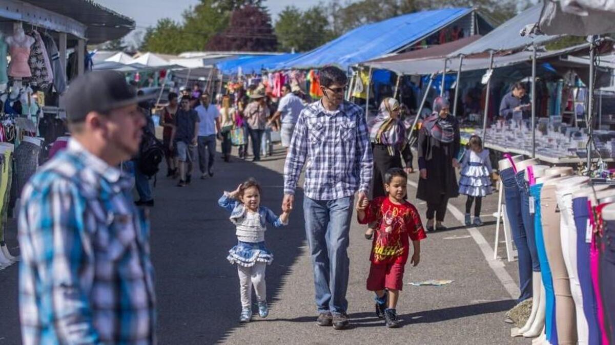 People shop at the Star Lite Swap Meet in Lakewood this month. Star Lite owner Hank Bardon has filed an appeal with the Lakewood hearing examiner challenging conditions the city placed on his business license earlier this month.