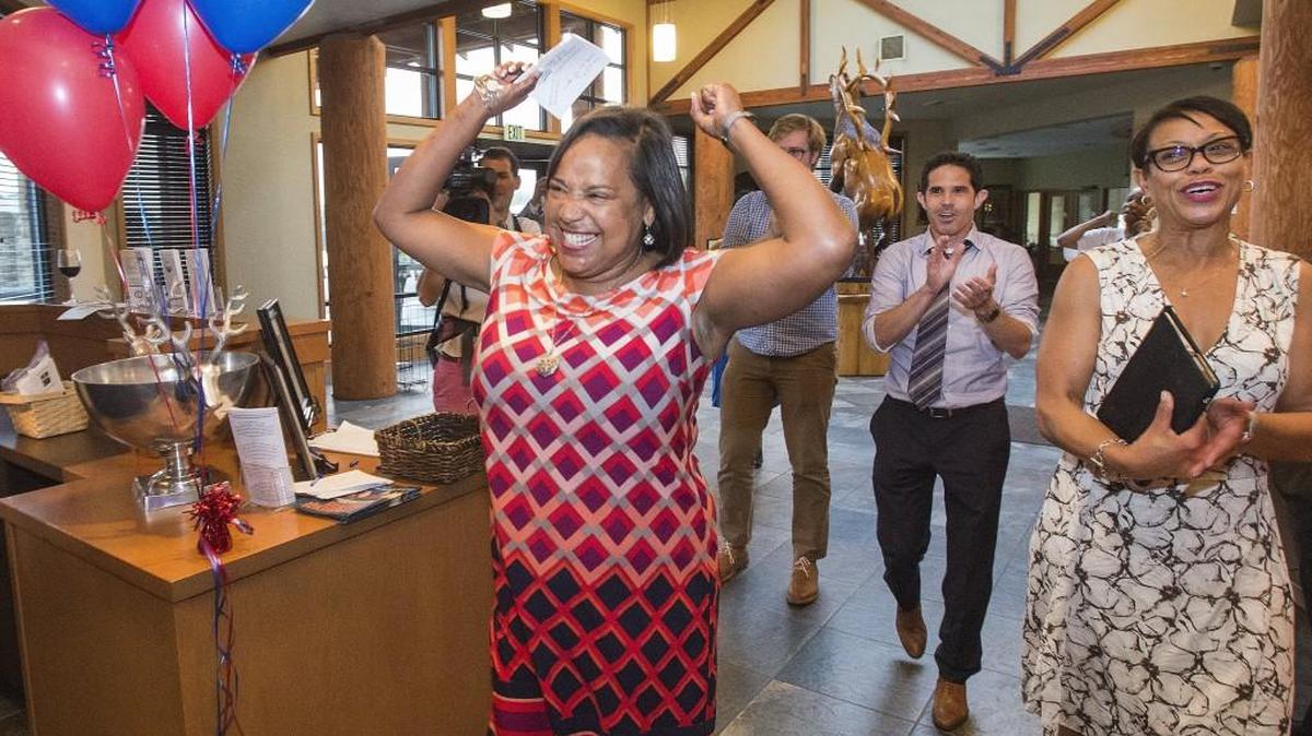 Tacoma mayoral candidate Victoria Woodards makes a giddy entrance into a room of supporters at the Urban Elk restaurant at Allenmore Golf Club in Tacoma on Tuesday. She was running neck-and-neck with candidate Jim Merritt but both appear to be headed to the general election in the fall. At right is Woodards’ best friend Violet Baker and Tacoma City Councilman Ryan Mello.
