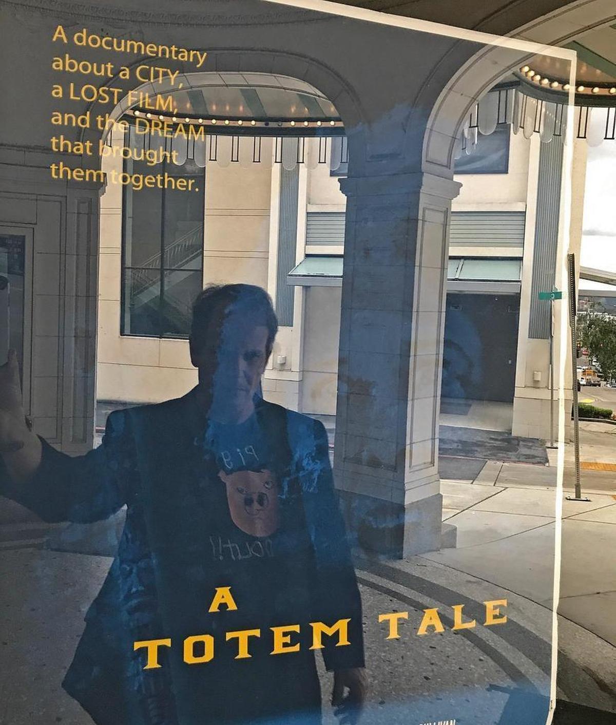 Tacoma-based filmmaker Mick Flaaen with a poster for his documentary “A Totem Tale.” An early version of the feature detailing Tacoma’s short-lived silent film industry will be screened for the public for the first time Friday. Photo courtesy of Mick Flaaen