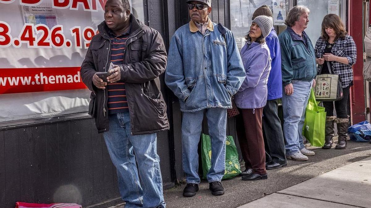 People waiting in line at Eloise’s Cooking Pot Food Bank in this 2017 file photo.