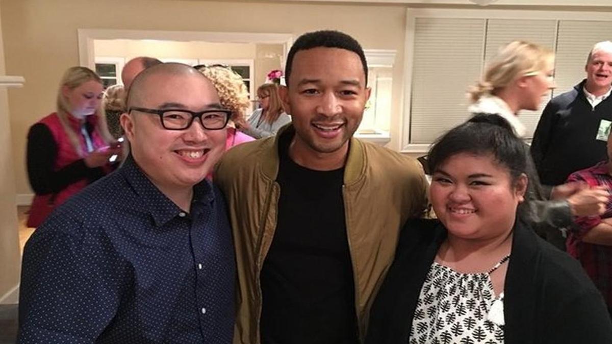 Seattle resident Jeff Lew (left) and his wife, Sophia Inton-Lew, with singer John Legend. Jeff Lew has started a campaign to raise at least $600,000 to eliminate lunch debt in school districts across Washington state.