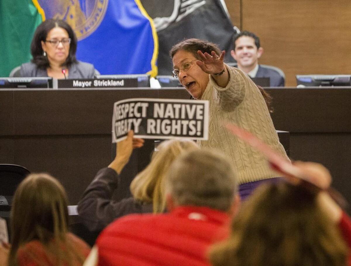 Marilyn Kimmerling leads the room in a protest song against Puget Sound Energy's proposed Port of Tacoma liquefied natural gas plant during the Citizens Forum on March 21, 2017. The City Council is considering a plan to alter the format of the monthly forum.