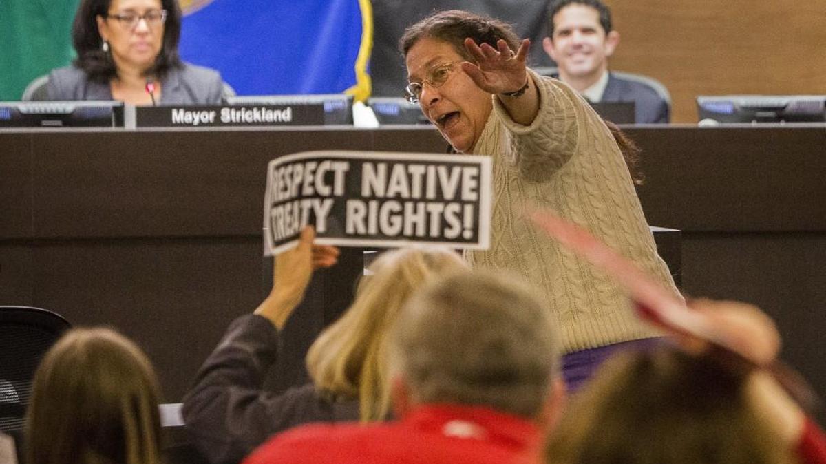 Marilyn Kimmerling leads the room in a protest song against Puget Sound Energy's proposed Port of Tacoma liquefied natural gas plant during the Citizens Forum on March 21, 2017. The City Council is considering a plan to alter the format of the monthly forum.