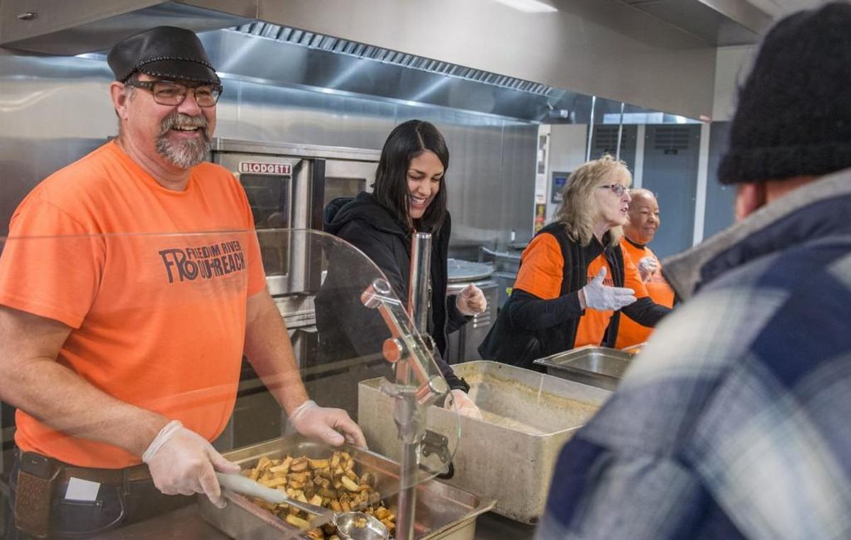 Volunteers Scott Nugent, left, Adriana Olivas, Marcia Keough and Janice Nugent serve breakfast to the guests at Nativity House.