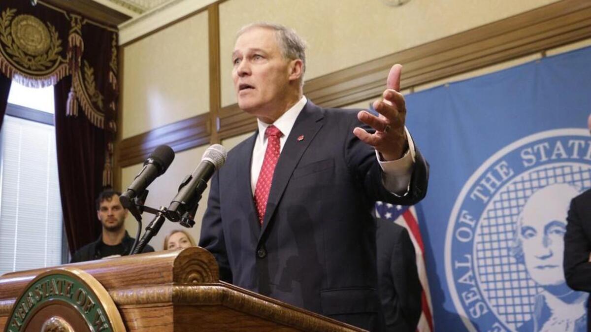 Gov. Jay Inslee talks to the media in Olympia on Wednesday, Dec. 13, 2017. He said the state will take steps to protect consumers regardless of how a vote by the Federal Communications Commission on a plan to undo the country's net-neutrality rules turns out. The FCC voted Thursday to roll back those rules.