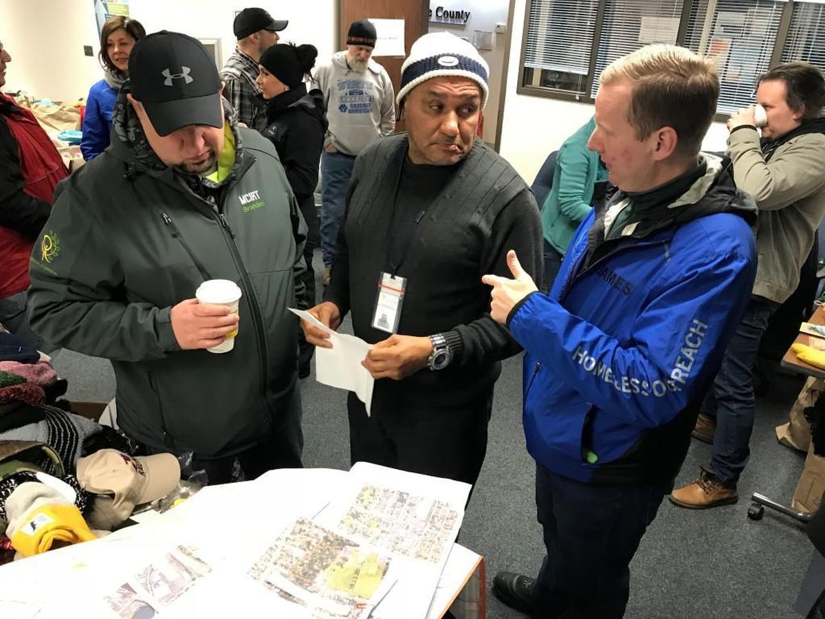 Volunteers, including Orlando Stumvoll, center, and James Pogue, right, prepare for this year’s Point-In-Time count.