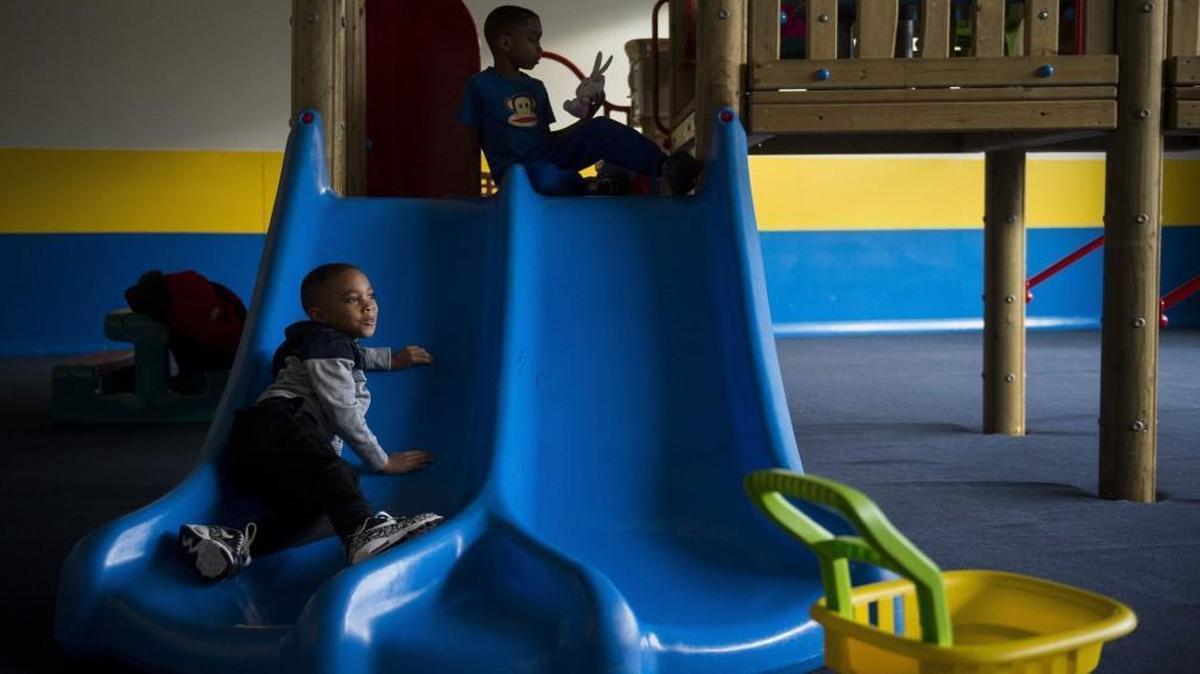 Nehemiah Johnson, 5, slides down a slide as Ezekiel Johnson, 6, plays with a toy Thursday, Feb. 8, at an indoor play area at the Tacoma apartment complex they live in. Their family is one of thousands in Pierce County that uses rental assistance provided by the Tacoma Housing Authority.