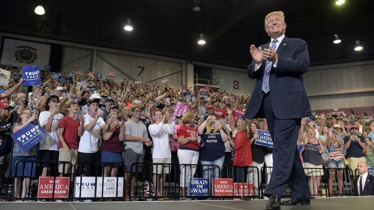 In this Aug. 3, 2017, photo, President Trump arrives to speak at a rally in Huntington, W.Va. White House officials have been urging the president to refocus on immigration and other issues that resonate with the conservatives, evangelicals and working-class whites who propelled him to the Oval Office.