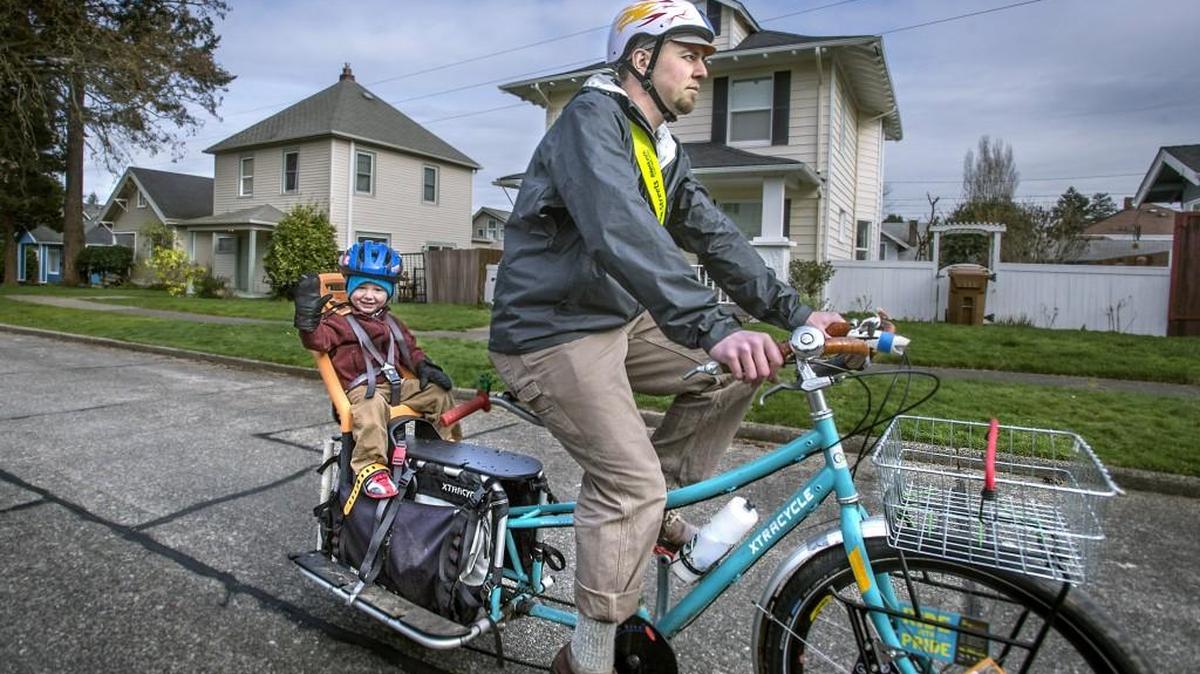 Matt Newport, of Tacoma, a stay at home dad and bicycle advocate, rides with his smiling co-pilot, son Malcolm, 2, as they run errands in their North Tacoma neighborhood Wednesday.