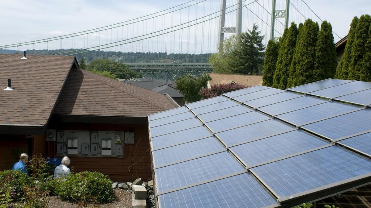 The south-facing garage of Dohn and Chris Swedberg has 25 Silicon Energy solar panels. The roof plane on their house that faces the Tacoma Narrows has another 24 (not pictured). The couple has maxed out their $5,000 annual incentive payment for the power they generate.