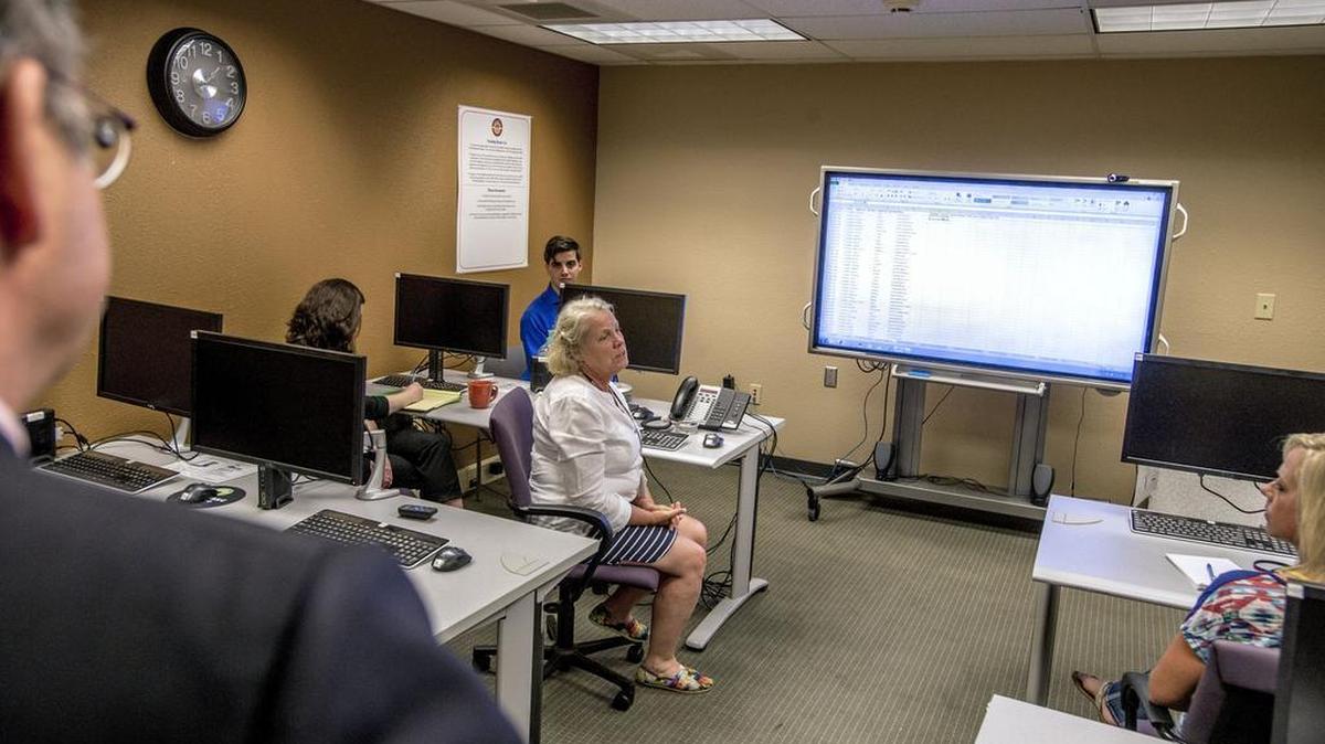 
Using a spreadsheet and a projector, technical analyst Jennifer Watts conducts the lottery for Tacoma Housing Authority in front of a small audience at the THA headquarters Wednesday.

