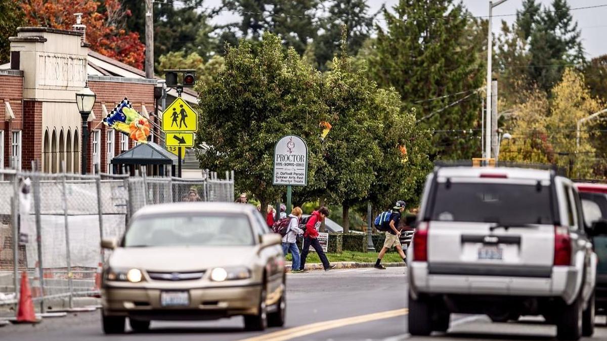 Students from Mason Middle School cross Proctor Street. Two children were seriously injured in a crosswalk accident a few blocks away.