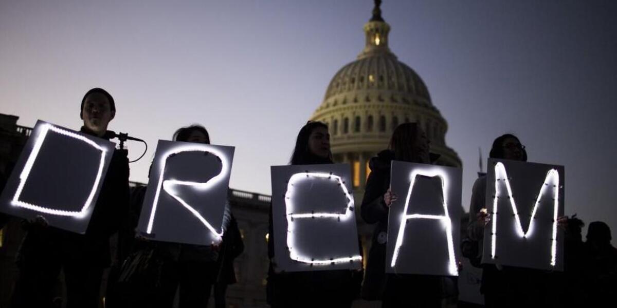 Demonstrators hold illuminated signs during a rally supporting the Deferred Action for Childhood Arrivals program (DACA), or the Dream Act, outside the U.S. Capitol building in Washington on Jan. 18, 2018.