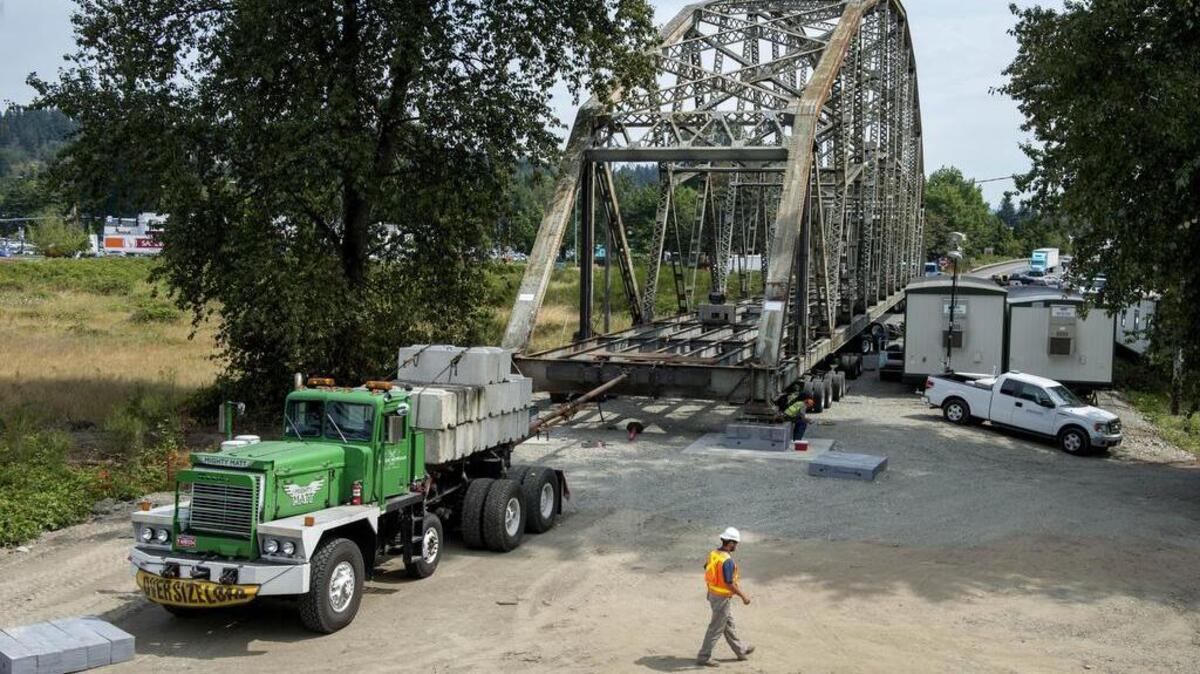 
The old steel truss northbound span of the state Route 167 Puyallup River Bridge was successfully moved Saturday night to this laydown yard off Meridian Avenue.  It took 12 hours to move, and transportation engineer Brian Whitehouse, shown walking in photo, said the process “went amazing. It was flawless from start to end. We finished 14 hours ahead of schedule.” 
