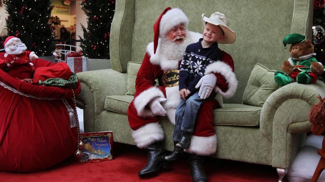 Jaxson Knight, 4, gets a case of the giggles while visiting Santa at the Tacoma Mall in 2013. Rick Harden, the mall’s longtime Santa, died Feb. 25.