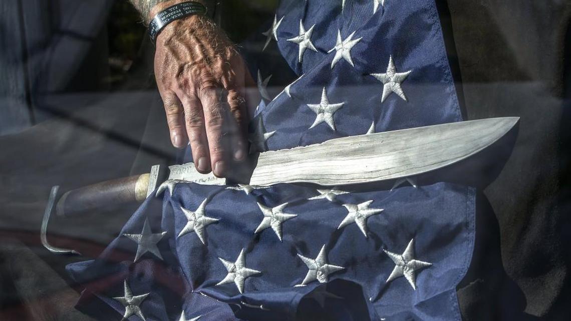 Combat veteran Boone Cutler, creator of the Spartan Pledge, runs his fingers along the Spartan Sword Saturday at Rally Point 6 in Lakewood before the sword was crated. It was then taken to an afternoon event at Pierce College in Puyallup that was designed to raise awareness and encourage action against suicide by veterans. The Spartan Sword was forged from 25 pounds of steel recovered from the World Trade Center towers after the 9/11 attacks and was used in the Refuse to Lose event by veterans taking the Spartan Pledge against suicide. Rally Point 6, a nonprofit organization, is a one-stop shop for Pierce County veterans services.
