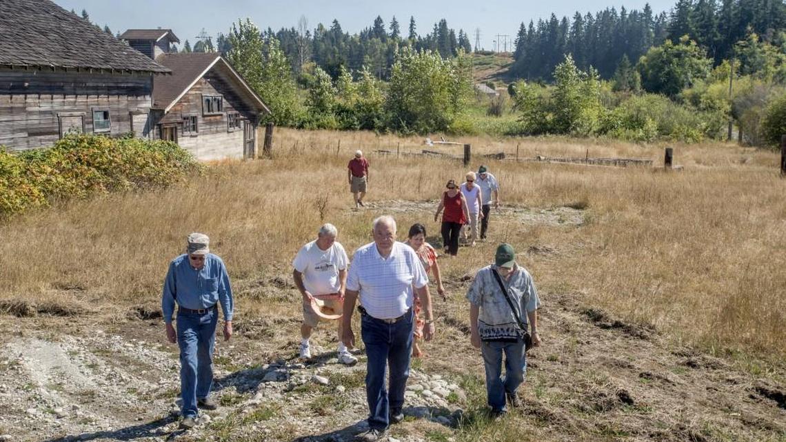 Stan Cross, center, and friends would like this county-owned property in Frederickson, the former Mayflower Dairy, to be developed for a park. It would be named Stan & Joan Cross Park, as it was their property prior to its sale to the county.