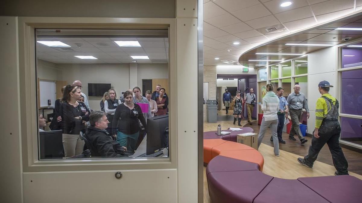 Mary Bridge Hospital staff in the Team Treatment Room, at left, get training on monitoring live streaming video of patient activities in rooms. The training was held as video crews and contractors walked the corridors of the Mary Bridge Adolescent Behavioral Health unit at Tacoma General Hospital when it opened in 2016.