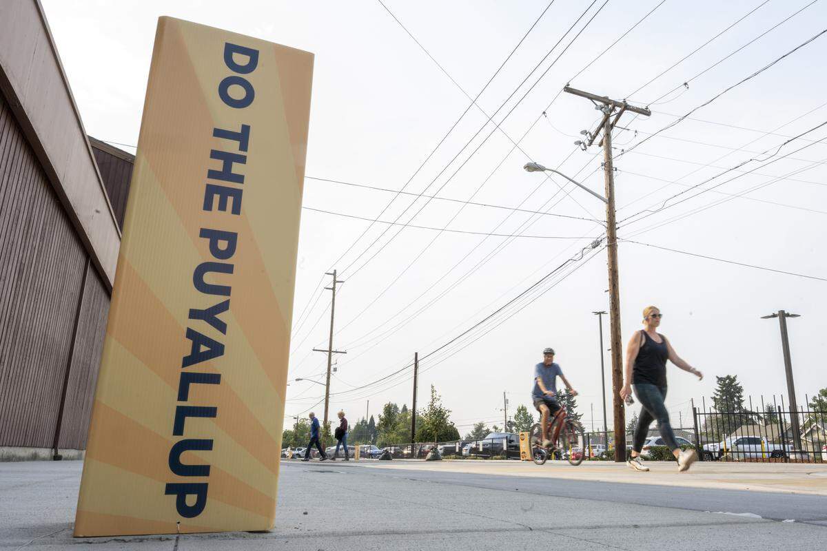 People walk along 9th Avenue Southwest on Thursday, Sept. 4, 2025, outside of the Washington State Fair Event Center in Puyallup, Wash.