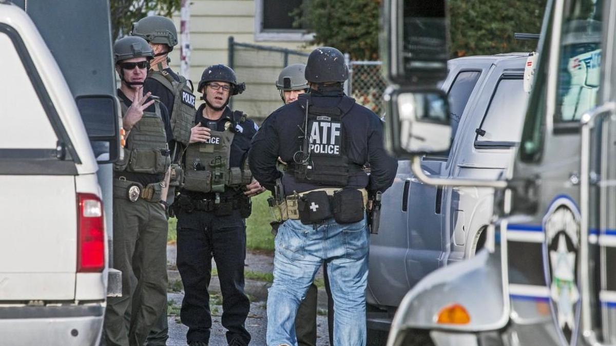 Tacoma Police and ATF agents organize themselves before heading into a house at E. 50th Street and McKinley Avenue East in Tacoma. It is believed that there may a bomb in the house.