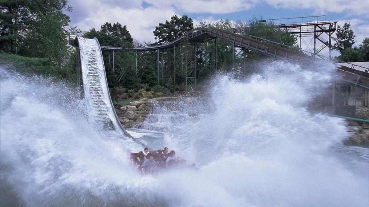 A boat splashes into a pond at Wild Waves and Enchanted Village.