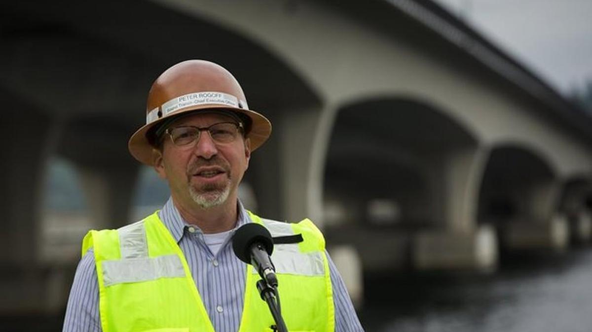 Sound Transit CEO Peter Rogoff speaks to the media about work being done so that light rail trains can travel over the I-90 floating bridge (in background) in this June 2017 photo. The Sound Transit board voted last week to negotiate terms of a new contract with Rogoff, who took over leadership of the agency in 2016.