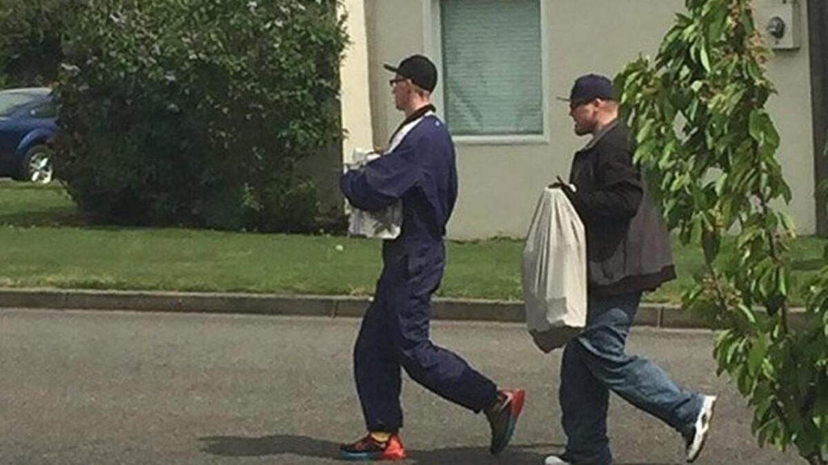 The two suspects in this photo provided by the Puyallup Police Department shed their outerwear and hats while police searched for them in connection with a burglary.